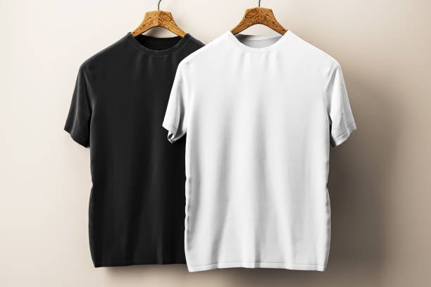 Black and white t-shirts on wooden hangers, displayed against a beige wall. Perfect for mockup presentations and design templates. 3D Rendering